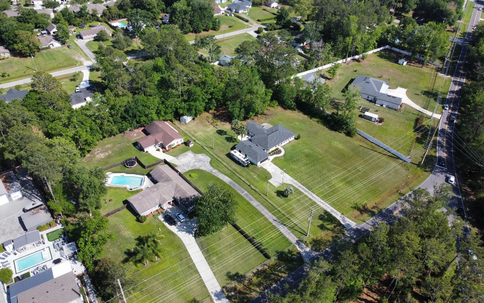 Tree lined streets and big yards from above on Fleming Island